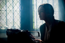 author writing at a typewriter